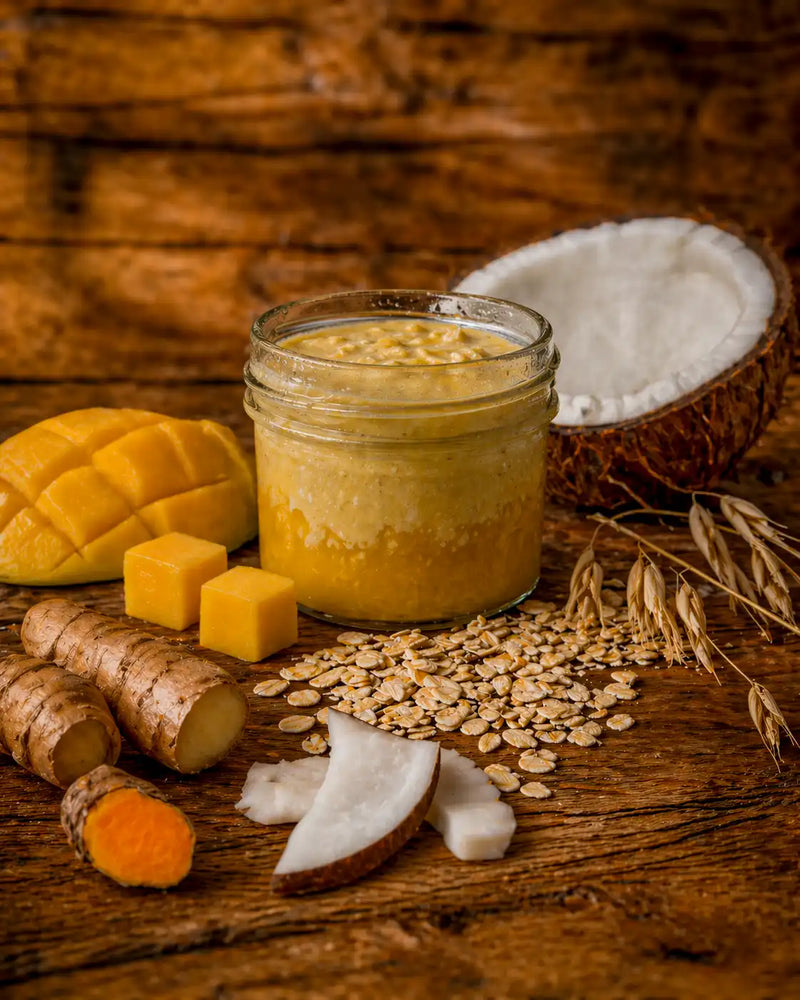 Open jar of SILK mango ginger overnight oats, golden creamy layers, with fresh mango and sprouted oats, Morning Energy