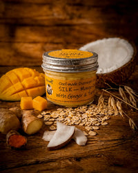 SILK mango ginger turmeric overnight oats jar with fresh mango, ginger and coconut on rustic wood, Morning Energy